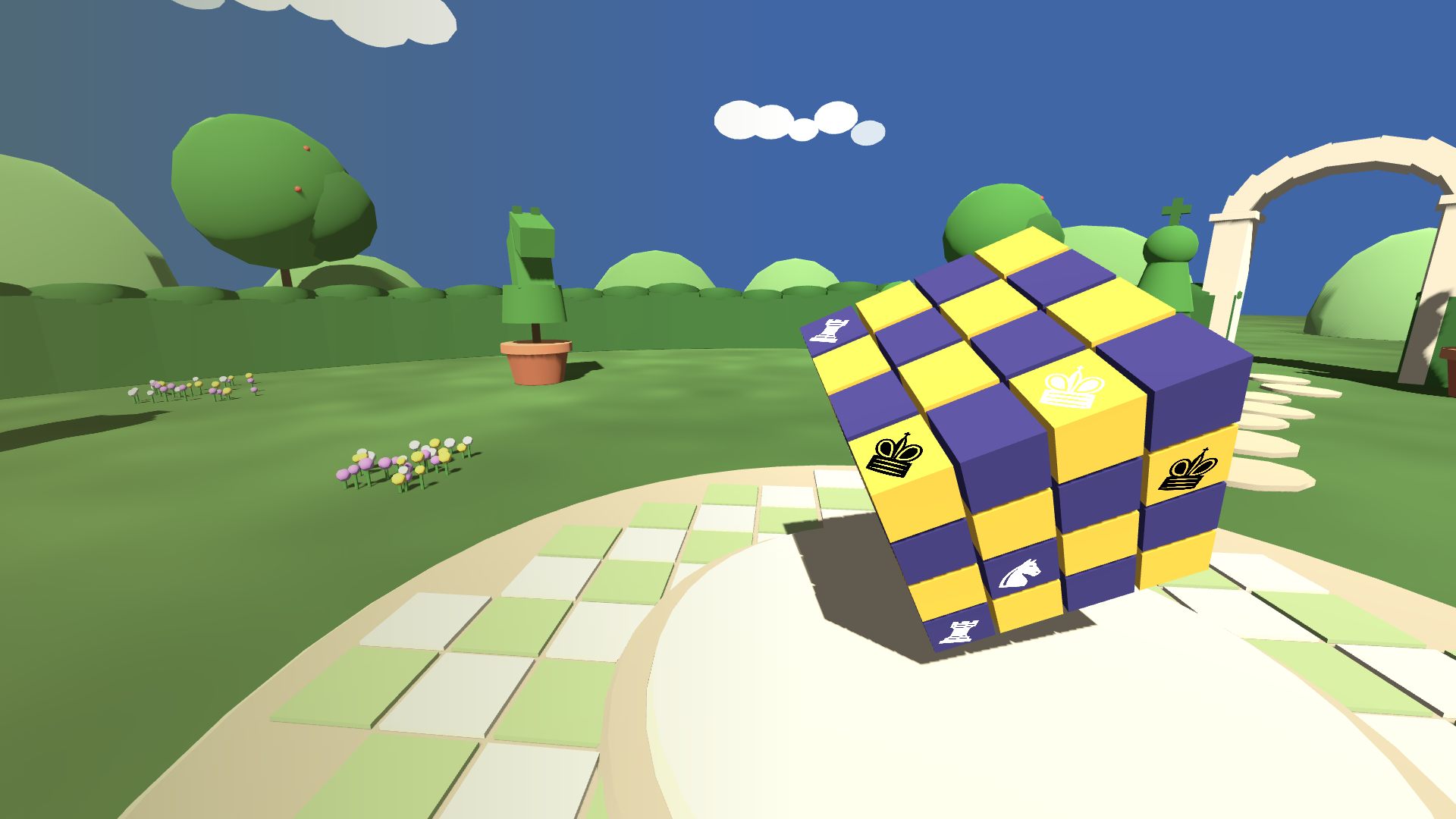 A yellow and purple chess cube resting on a pedestal in a green garden with topiary chess pieces